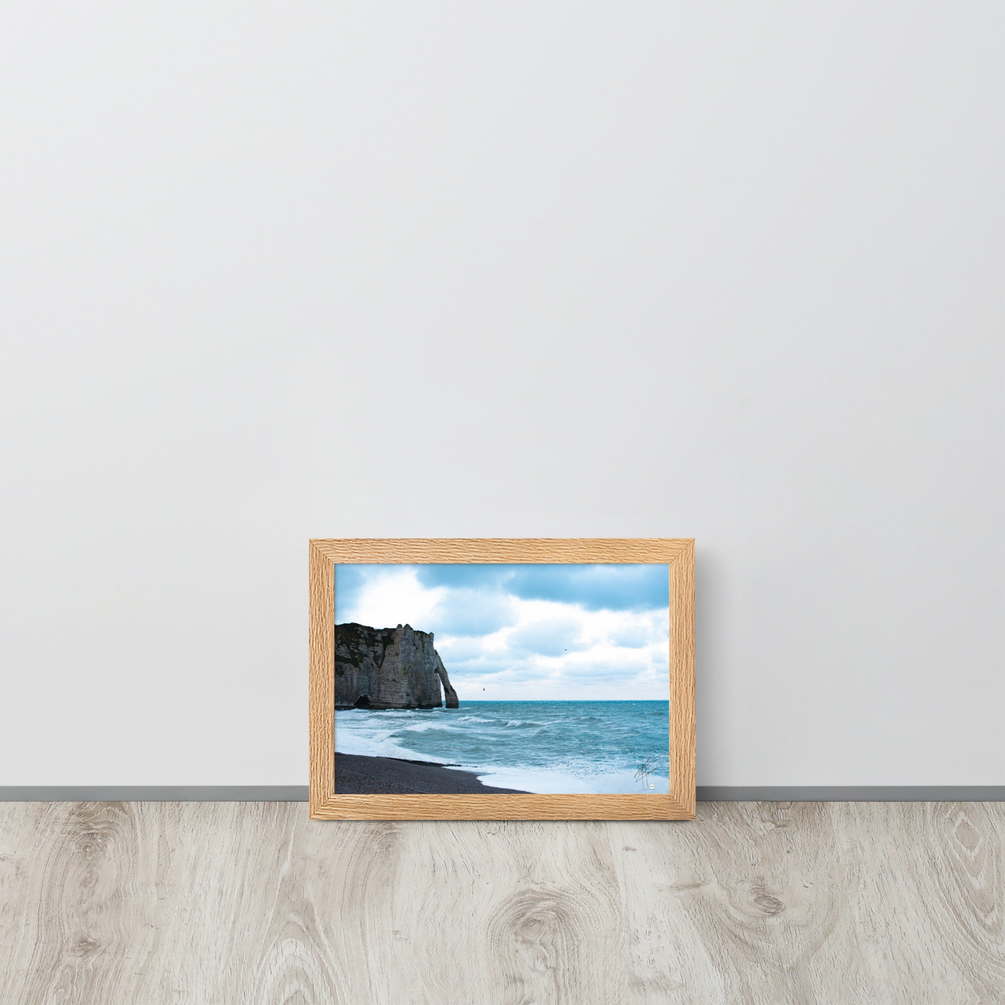 Photographie apaisante de la plage d'Etretat, où la mer caresse le rivage sous un ciel clair. Une représentation parfaite de la tranquillité et de la beauté naturelle de la côte normande.