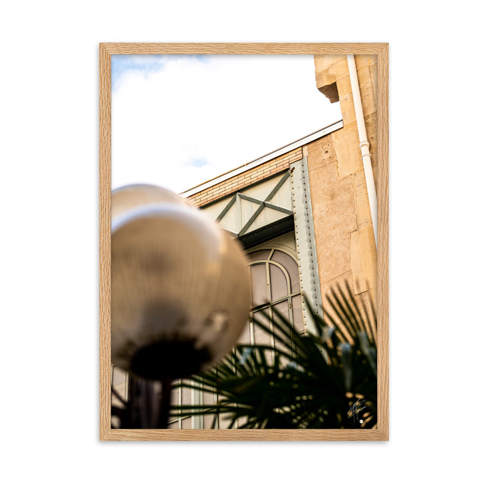 Photographie mettant en lumière l'architecture marocaine avec sa pierre jaune, une silhouette de palmier et des éléments industriels, évoquant un voyage exotique.