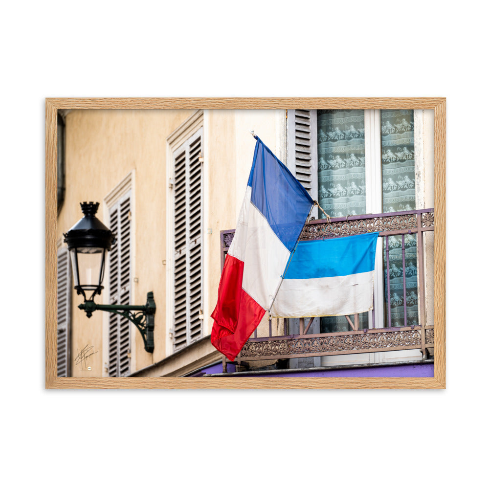 Photographie du drapeau tricolore français suspendu à un garde-corps métallique, représentant à la fois la tradition et la modernité, encadrée pour une mise en valeur murale.