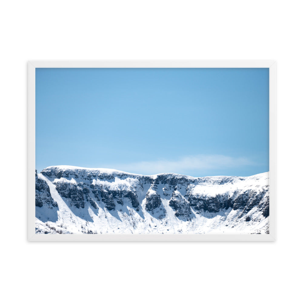 Photographie des montagnes enneigées du Cantal sous un ciel bleu ensoleillé