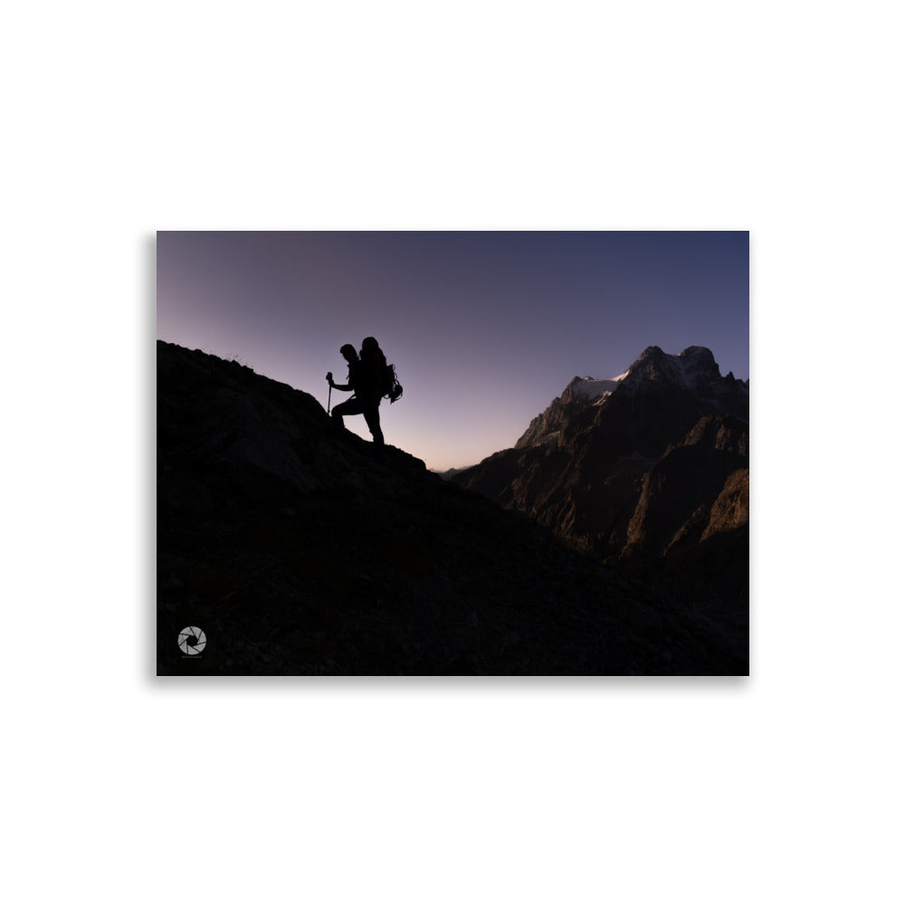 Photographie d'un randonneur progressant sur une montagne au crépuscule, capturée par Brad Explographie, illustrant la beauté et le défi de l'ascension dans un décor montagneux impressionnant.