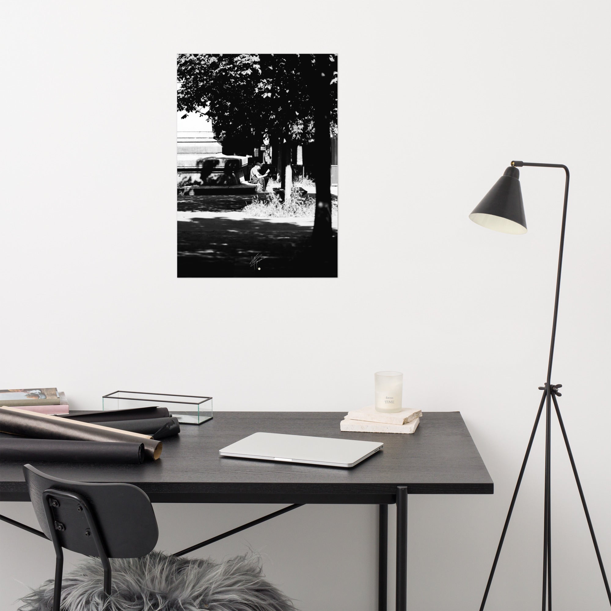 Poster photographique 'L'heure de lire', capturant un homme lisant un livre à Paris, en noir et blanc.