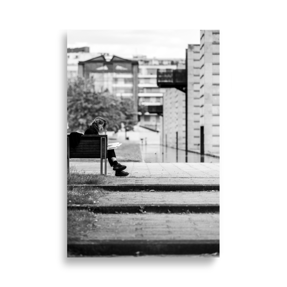 Dame lisant un livre sur un banc du Parc André Citroën, Paris.