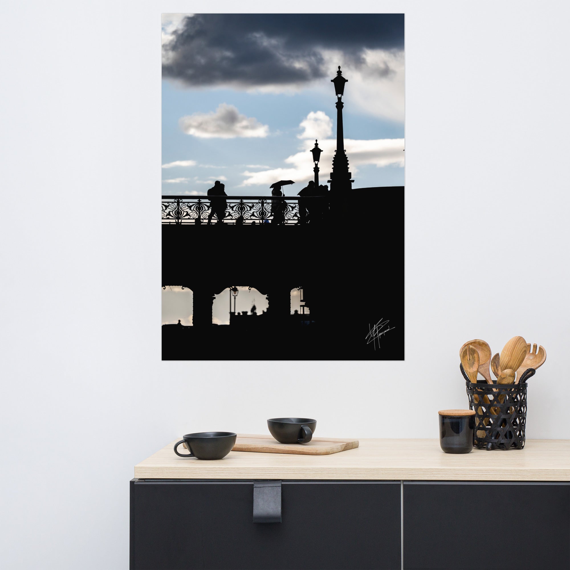 Des passants sur un pont parisien avec un ciel azur en arrière-plan, orné de nuages blancs et gris.