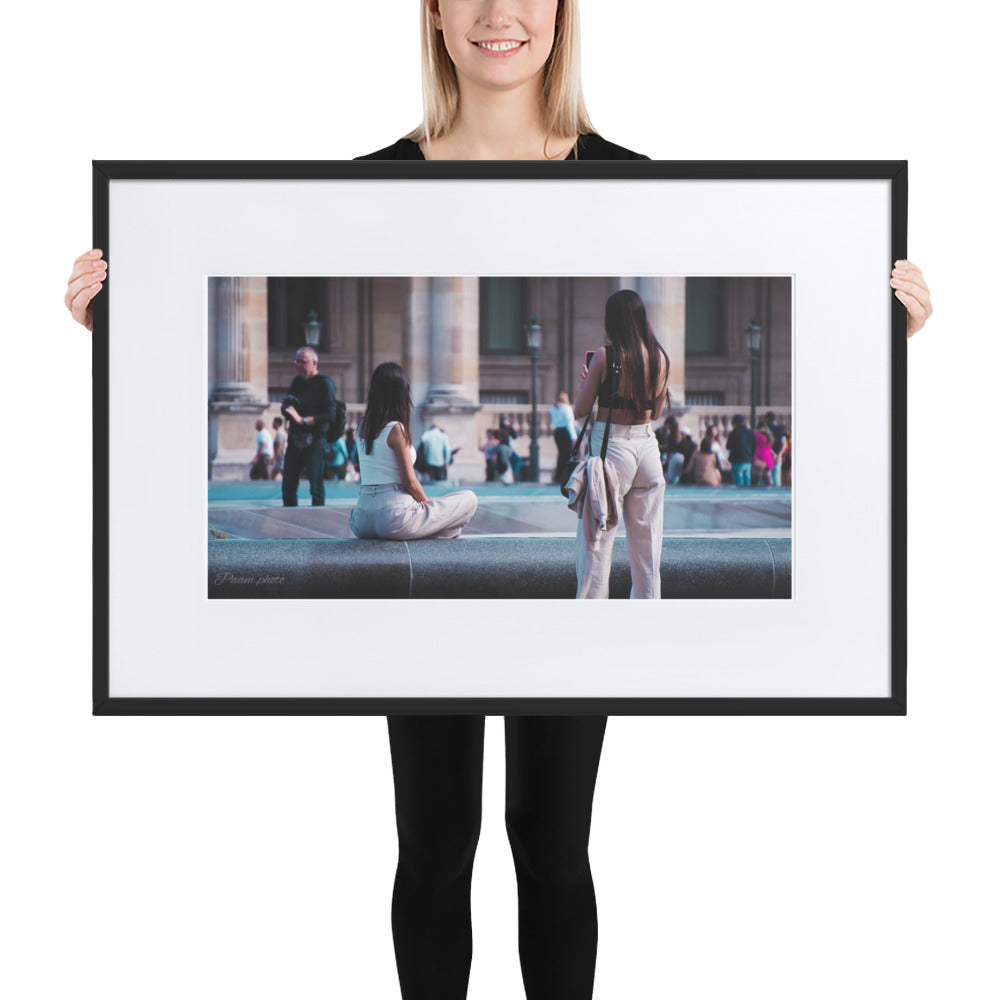 Photographie 'Mesdames' par Pamm.Photo montrant deux jeunes femmes dans une scène quotidienne près du Louvre à Paris, symbolisant l'amitié et la beauté des moments spontanés.