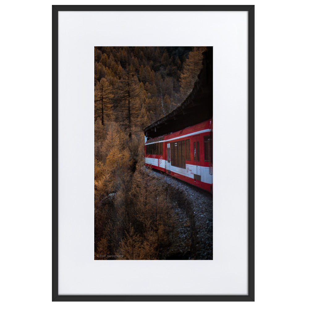 Train rouge serpentant à travers une forêt d'automne, photographié depuis un wagon avec une vue plongeante par Brad_explographie.